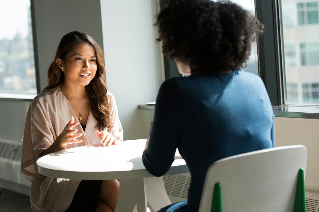 Scène d'entretien, deux femmes dont une de dos. Celle de face parle et semble confiante